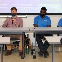 Panel speaking with service dog